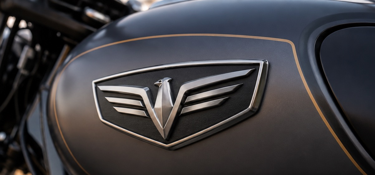 3D chrome wing emblem badge on dark motorcycle tank